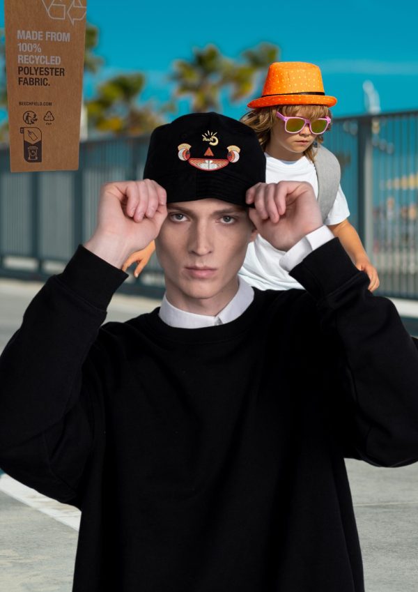 Teenage boy wearing a Myllo embroidered bucket hat at a skatepark