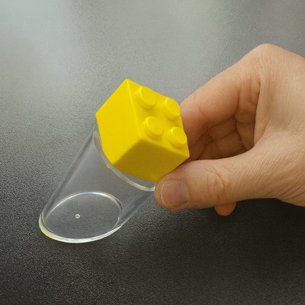 Toy placed over Choke Tester showing it does not fit inside – safe to use.