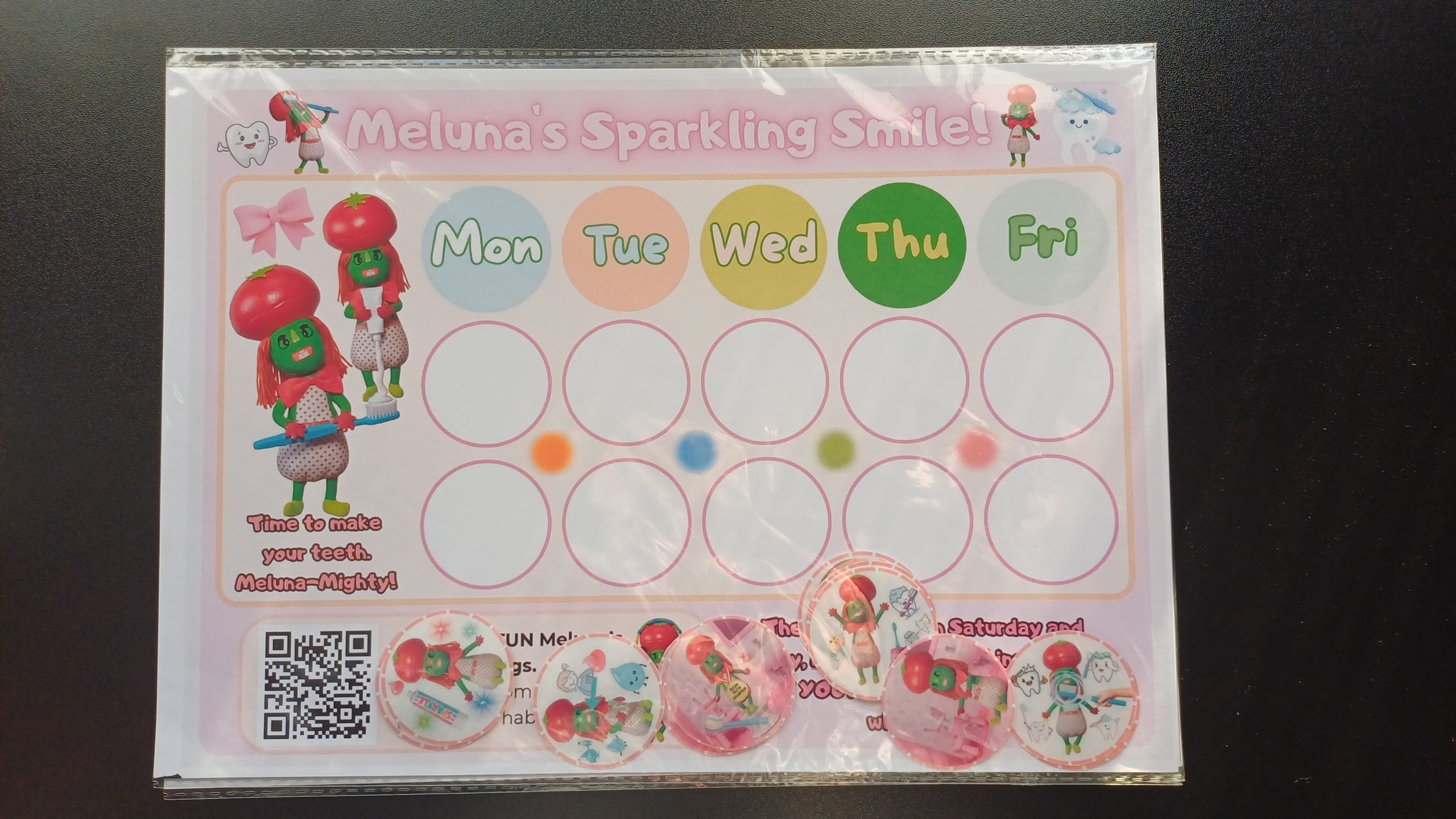 omplete Meluna routine tracker kit showing A4 chart and 12 hand-cut 40mm holographic reward stickers.