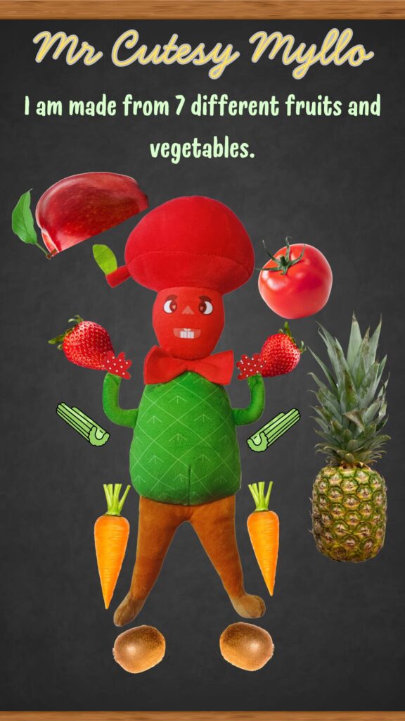 Promotional image of Mr. Cutesy Myllo, a plush toy designed with elements representing seven different fruits and vegetables: a red apple for his head, beetroot, strawberries, a pineapple, celery, carrots, and kiwi, arranged around him against a dark background.